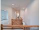 Bright hallway with wood railing and hardwood floors leads to other rooms at 2511 Dundeen St, Charlotte, NC 28216
