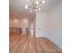 Spacious hallway with hardwood floors, modern lighting and stairwell at 2511 Dundeen St, Charlotte, NC 28216