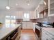 Contemporary kitchen with stainless steel appliances, white cabinets, and an island, providing both style and functionality at 2511 Dundeen St, Charlotte, NC 28216