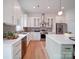 Well-lit kitchen featuring stainless steel appliances, white cabinets, stylish backsplash, and modern fixtures at 2511 Dundeen St, Charlotte, NC 28216