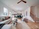Bright open-concept living space with modern decor and hardwood floors flows into the kitchen and dining area at 2511 Dundeen St, Charlotte, NC 28216