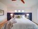 Comfortable main bedroom features a statement headboard and soft, natural light at 2511 Dundeen St, Charlotte, NC 28216