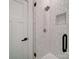 Close-up of shower with marble tiling and a rainfall shower head at 2511 Dundeen St, Charlotte, NC 28216