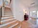 Inviting foyer with hardwood stairs and an elegant table vignette at 2511 Dundeen St, Charlotte, NC 28216