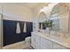 Elegant bathroom featuring double sinks, classic fixtures, and stylish navy blue wall paneling at 2536 Grantham Place Dr, Fort Mill, SC 29715