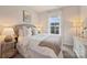 This bedroom features a bright window, neutral paint, and a side table at 2536 Grantham Place Dr, Fort Mill, SC 29715