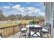 This back deck features outdoor seating, a wooded view, and clear skies at 2536 Grantham Place Dr, Fort Mill, SC 29715