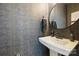 Stylish powder room featuring a pedestal sink, a round mirror, and textured gray wallpaper at 2536 Grantham Place Dr, Fort Mill, SC 29715