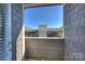 View from a patio overlooking complex with shingle siding and a shared courtyard at 301 E Tremont Ave # 314, Charlotte, NC 28203