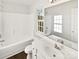 Clean bathroom with a shower-tub combo, a single sink, and hardwood floors at 3161 Glen Robin Ct, Charlotte, NC 28205