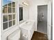 Bathroom features a single vanity, toilet, mirror, vanity lights, and a window at 3161 Glen Robin Ct, Charlotte, NC 28205