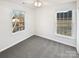 Bedroom features two windows, carpeted floor, neutral walls, and a ceiling fan at 3161 Glen Robin Ct, Charlotte, NC 28205
