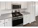 Kitchen boasts stainless steel appliances, white cabinetry, and plenty of counter space at 3161 Glen Robin Ct, Charlotte, NC 28205