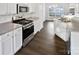 Modern kitchen with stainless steel appliances, white cabinets, and hardwood floors at 3161 Glen Robin Ct, Charlotte, NC 28205