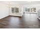 Spacious living room with hardwood floors and natural light, plus a chandelier at 3161 Glen Robin Ct, Charlotte, NC 28205