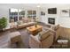 Bright living room with large windows, fireplace, modern furniture, and hardwood floors at 3161 Glen Robin Ct, Charlotte, NC 28205