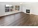 Spacious, naturally lit living room featuring a fireplace and beautiful hardwood floors at 3161 Glen Robin Ct, Charlotte, NC 28205