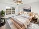 Inviting main bedroom features a tray ceiling, ceiling fan, and a large bright window at 3161 Glen Robin Ct, Charlotte, NC 28205