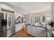 Bright kitchen flows to breakfast nook, showcasing stainless appliances and granite countertops at 324 Courtney Ln, Matthews, NC 28105