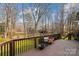 Wooden deck overlooking a spacious backyard with lush lawn and mature trees at 3536 Wylie Meadow Ln, Charlotte, NC 28269