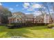 Spacious backyard features mature trees, manicured landscaping, and back patio at 3536 Wylie Meadow Ln, Charlotte, NC 28269