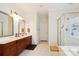 Spacious bathroom with dual vanities, framed mirrors, tile floor, and glass shower at 3536 Wylie Meadow Ln, Charlotte, NC 28269