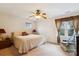 Comfortable bedroom featuring a ceiling fan, window with view, and chair at 3536 Wylie Meadow Ln, Charlotte, NC 28269