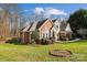 Brick home featuring lush lawn and mature landscaping at 3536 Wylie Meadow Ln, Charlotte, NC 28269