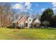 Beautiful brick home with lush green lawn and mature trees at 3536 Wylie Meadow Ln, Charlotte, NC 28269