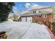 Spacious three-car garage with a large driveway and brick exterior at 3536 Wylie Meadow Ln, Charlotte, NC 28269