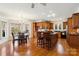 Open-concept kitchen with island, stainless steel appliances, and a dining area at 3536 Wylie Meadow Ln, Charlotte, NC 28269