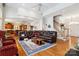 Open-concept living room with hardwood floors and seamless flow to the kitchen and staircase at 3536 Wylie Meadow Ln, Charlotte, NC 28269