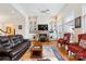 Cozy living room featuring built-in shelves, a stone fireplace, and comfortable seating at 3536 Wylie Meadow Ln, Charlotte, NC 28269