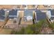 An aerial view of a home with fenced backyard in a suburban neighborhood with mature trees at 4159 Millstream Rd, Denver, NC 28037