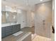 Spacious bathroom with tile flooring, large vanity, dual shower heads, and glass enclosure at 4159 Millstream Rd, Denver, NC 28037