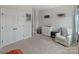 Serene bedroom features a cozy armchair, changing table, and ample closet space for comfortable and organized living at 4159 Millstream Rd, Denver, NC 28037