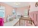 Adorable bedroom with twin beds and decor for children, with natural light from the window at 4159 Millstream Rd, Denver, NC 28037