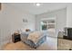 Comfortable bedroom features a queen bed, neutral colors, and a window view of the backyard at 4159 Millstream Rd, Denver, NC 28037