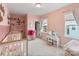 Charming bedroom features pink walls, twin beds, and a delightful play area with a vanity and dress-up rack at 4159 Millstream Rd, Denver, NC 28037