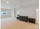 Large bonus room with neutral carpeting, a futon sofa, and lots of natural light at 4159 Millstream Rd, Denver, NC 28037