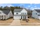 Charming two-story home with a two car garage, black trim, covered front porch and well-manicured lawn at 4159 Millstream Rd, Denver, NC 28037
