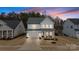 Stunning two-story home with a two-car garage, covered porch, and manicured lawn at 4159 Millstream Rd, Denver, NC 28037
