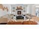 Cozy living room with a fireplace, large windows, and comfortable seating at 4159 Millstream Rd, Denver, NC 28037