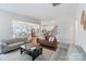 Spacious living room boasts hardwood floors and an open floor plan with views into the kitchen and dining areas at 4159 Millstream Rd, Denver, NC 28037