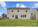 Expansive backyard featuring a lush lawn, and a view of the home's back facade with sliding glass doors at 5735 Olive Beach Rd, Kannapolis, NC 28081