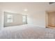 Spacious bedroom with neutral carpet, two large windows, and ample closet space at 5735 Olive Beach Rd, Kannapolis, NC 28081