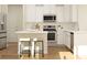 Modern kitchen featuring stainless steel appliances, a center island with seating, and white cabinets at 5735 Olive Beach Rd, Kannapolis, NC 28081