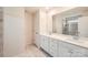 Stylish bathroom with dual vanities, a large mirror, and a walk-in shower with tiled walls at 5735 Olive Beach Rd, Kannapolis, NC 28081
