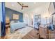 Comfortable bedroom with a ceiling fan, stylish rug, and dark blue accent wall at 6017 Rose Valley Dr, Charlotte, NC 28210