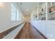 Hallway with bench and built-in shelving and hardwood flooring at 6017 Rose Valley Dr, Charlotte, NC 28210